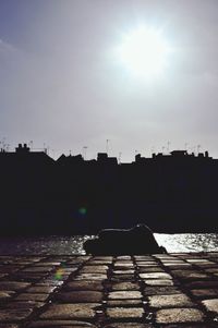 Silhouette city against sky during sunset