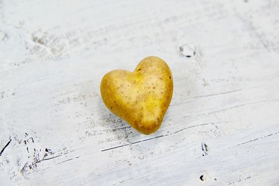 High angle view of heart shape potato on table