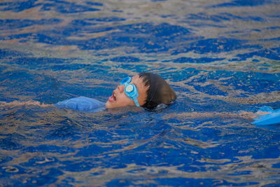 High angle view of girl swimming in pool