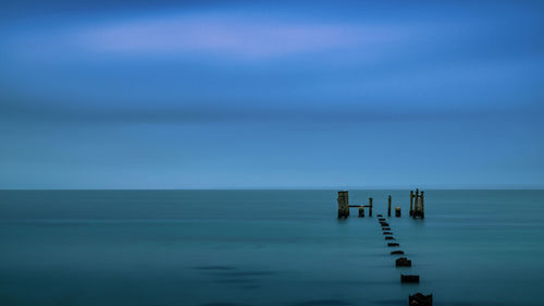 Scenic view of sea against clear blue sky