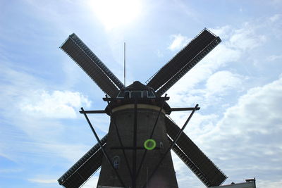 Low angle view of traditional windmill against sky