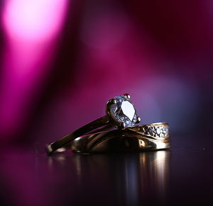 Close-up of rings on table against colored background