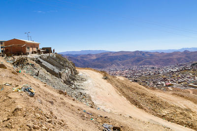 Scenic view of landscape and mountains against clear sky