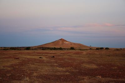 Scenic view of arid landscape against sky