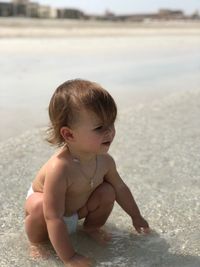 Baby girl on shore at beach