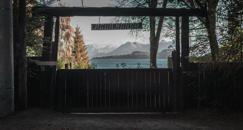 Text hanging at lakeshore against mountains