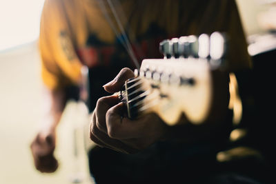 Close-up of man playing guitar