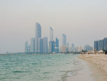 Panoramic view of sea and buildings against clear sky