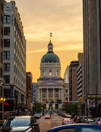 Buildings in city against sky during sunset