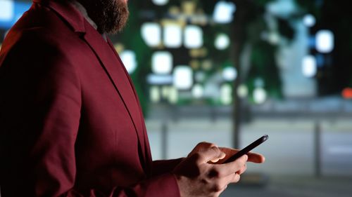 Midsection of woman using mobile phone