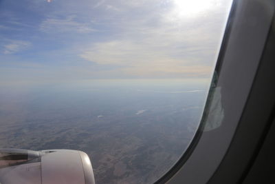 Aerial view of landscape seen through airplane window