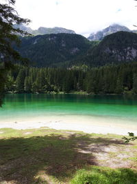 Scenic view of lake by mountains against sky