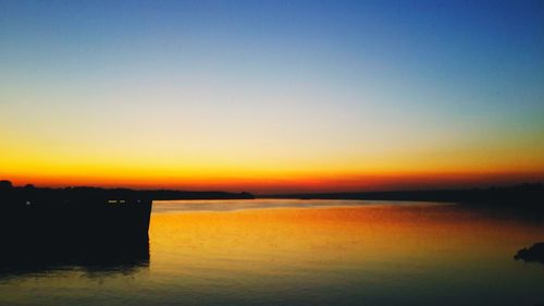 Scenic view of sea against romantic sky at sunset