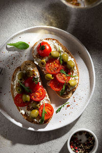 Plate with bruschettas and glass of wine