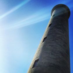 Low angle view of tower against blue sky