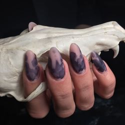 Close-up of woman hand against black background