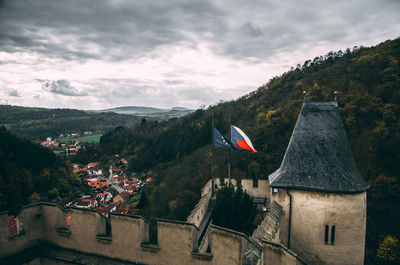 High angle view of flags on tower against cloudy sky