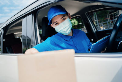 Portrait of man sitting in car