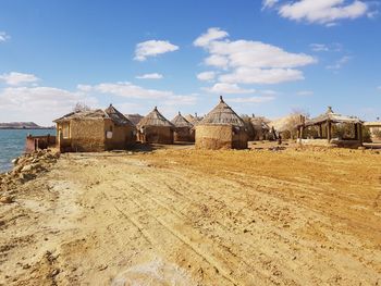 Houses on field against sky