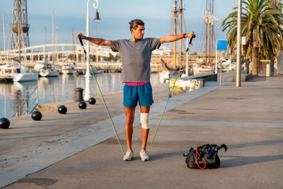 Young latin man doing exercise outside