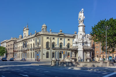Fountain of catalan genius on palau square in barcelona, spain