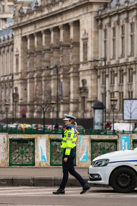 Full length of man standing on street in city