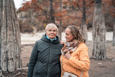 Man and woman standing in park during winter