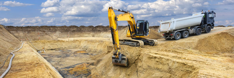 Excavator is working and digging at construction site