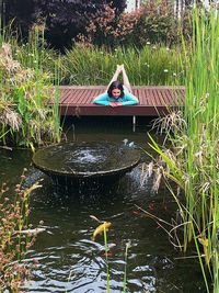 Young woman swimming in lake