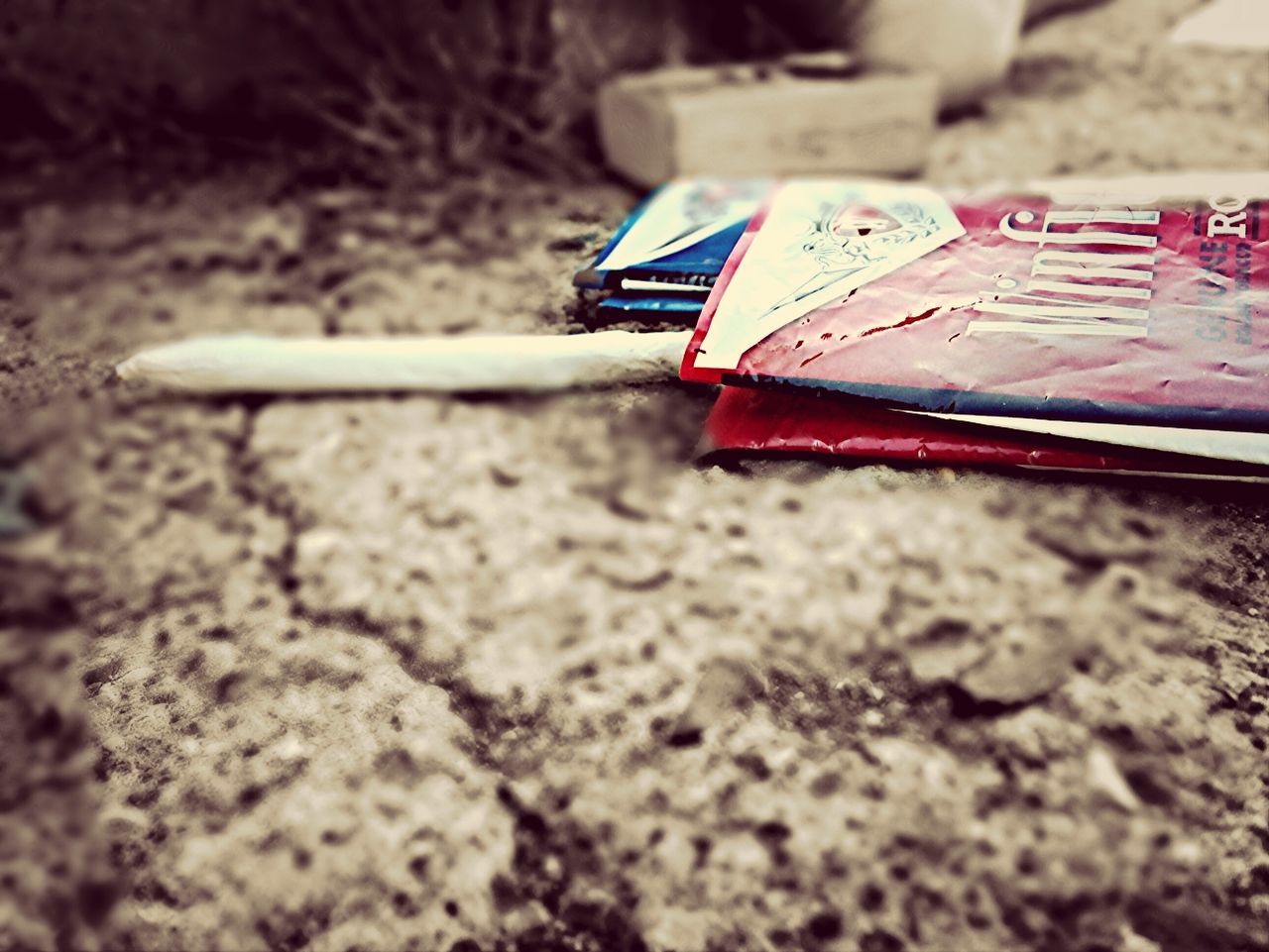 selective focus, close-up, focus on foreground, text, still life, communication, high angle view, single object, no people, western script, day, toy, wood - material, outdoors, number, table, group of objects, plastic, variation, sunlight