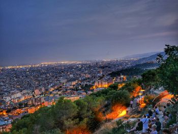 High angle view of illuminated cityscape against sky at dusk