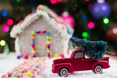 Close-up of gingerbread house with christmas decorations at home