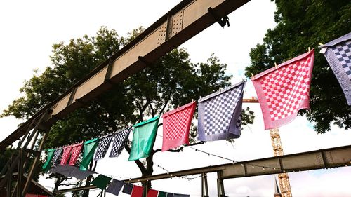 Low angle view of flags hanging on tree