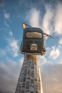 Low angle view of information sign against sky