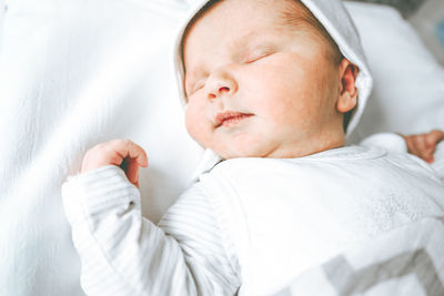 High angle view of baby sleeping on bed