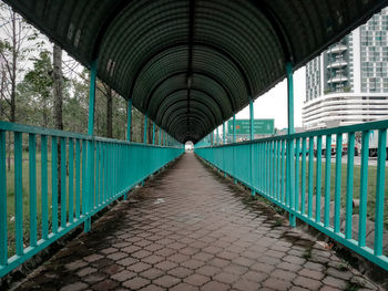 Empty bridge over canal in city