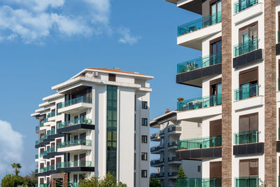 Cityscape of a residential area with modern apartment buildings on a sunny day.