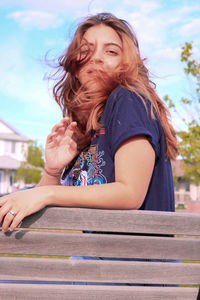 Portrait of a smiling young woman sitting outdoors