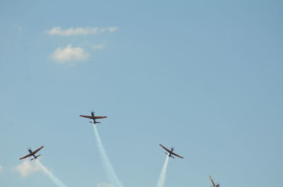 Low angle view of airplane flying against sky