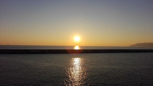 Scenic view of sea against sky at sunset
