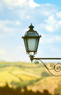 Low angle view of street light on field against sky