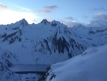 Scenic view of snow covered mountains against sky