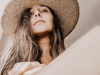 Portrait of beautiful young woman in hat