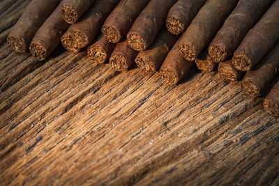Close-up of cigars on wooden table