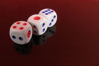 Close-up of dices on red background