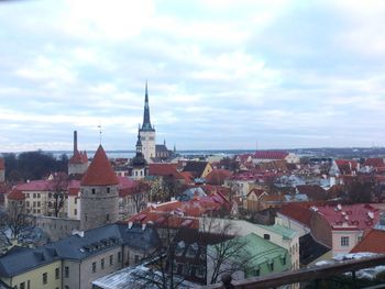 Cityscape against cloudy sky