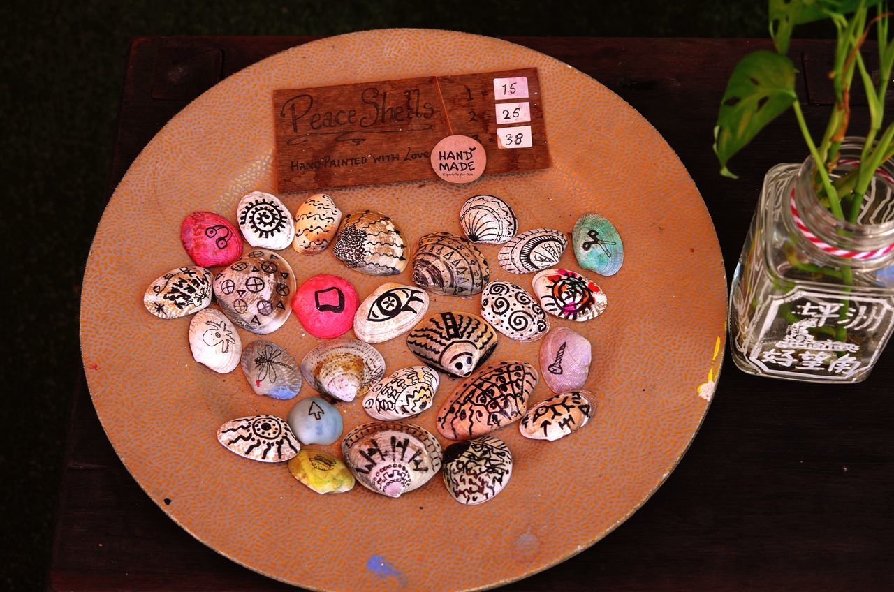 HIGH ANGLE VIEW OF MULTI COLORED TABLE ON PLATE