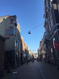 Street amidst buildings against sky in city