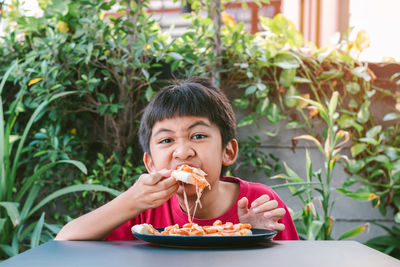 Portrait of boy eating food