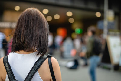 Rear view of young woman on city street